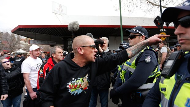 An anti-mosque protester yells over police lines at the rally. 