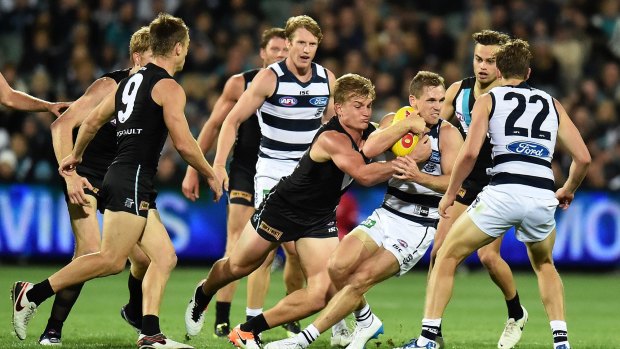 Geelong captain Scott Selwood is taken down by Ollie Wines of the Power.