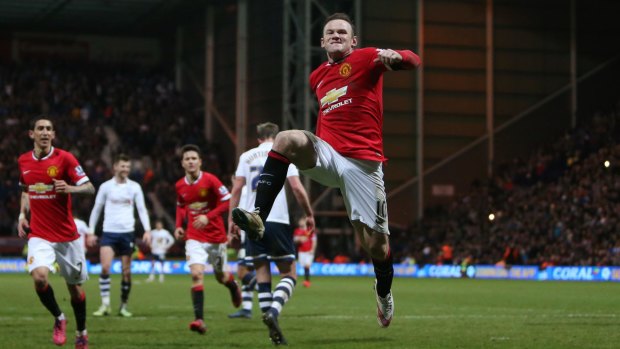 Manchester United's Wayne Rooney celebrates scoring their third goal with a penalty.
