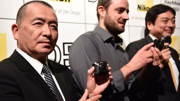 Nikon Senior Vice President Nobuyoshi Gokkyu (left) shows off the KeyMission 360.