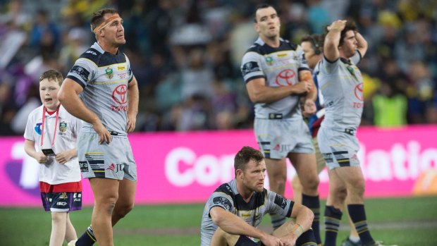 Beaten: Dejected North Queensland Cowboys players at full-time in the NRL grand final.