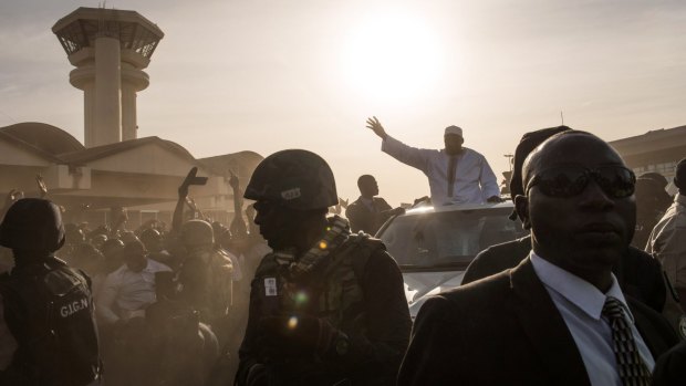 Barrow, waving, had been staying in Senegal after authoritarian ex-president Yahya Jammeh refused to step down following Gambia's December election results. 