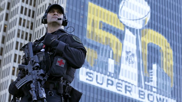 San Francisco Police tactical unit officer Jeff McHale watches the crowd at Super Bowl City in San Francisco. Security abounds in the lead-up to the match.