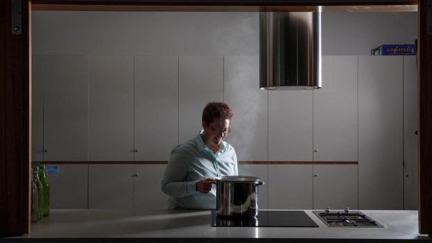 Ginninderry sustainability manager Jessica Stewart demonstrates the highly efficient induction cooktops that will be used in the first stage of the development's residential precinct instead of gas.