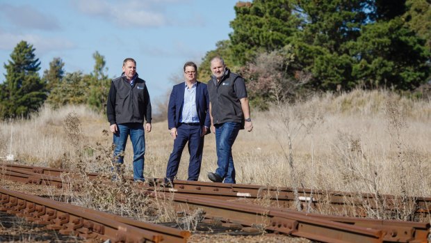 Director of Capital Recycling Adam Perry, Dean Ward from ActewAGL, and project manager Ewen McKenzie at the Fyshwick site where works for a railway siding have been approved as part of a massive new plan to deal with Canberra's rubbish.
