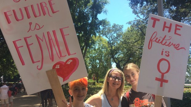 Alex McKoy, 11, Caitlin McKoy, and Indie Margin, 16, attending the Sydney women's march on Sunday.