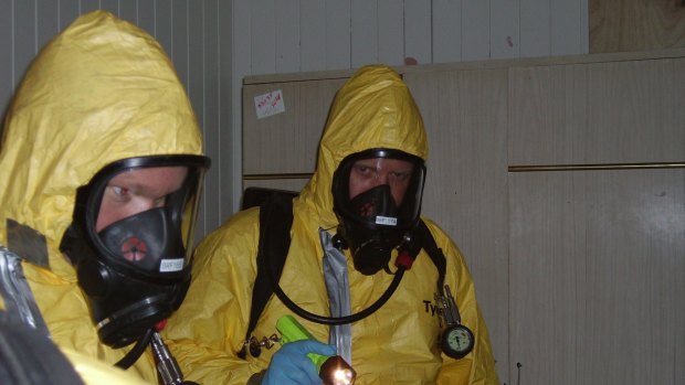 Police don safety gear while dealing with another illegal lab.