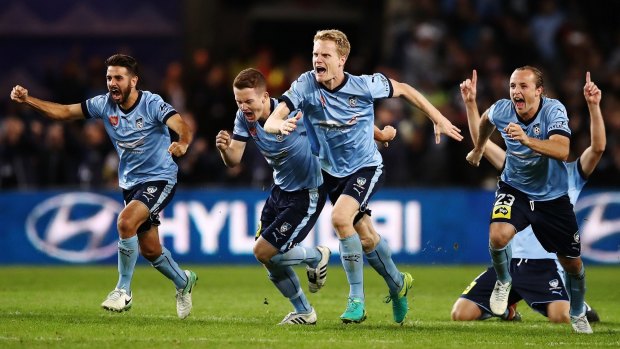 Sydney FC players celebrate after Milos Ninkovic kicked the winning goal in the shoot-out.
