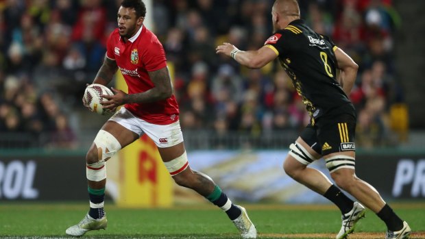 In the mix: Courtney Lawes of the Lions charges towards Brad Shields of the Hurricanes during their clash in Wellington on Tuesday. 