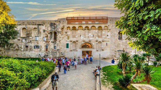 Tourists outside the ancient Golden Gate to the Diocletian's Palace section of the Old Town of Split, Croatia.