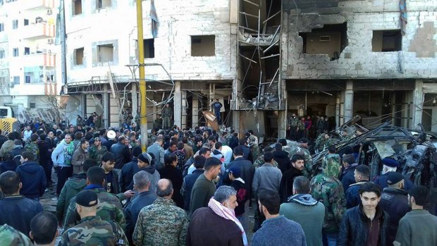 Syrians gathered at the site where three bombs exploded in Sayyda Zeinab, a predominantly Shiite Muslim suburb in Damascus, on Sunday.