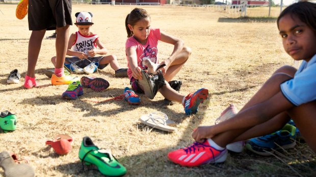 Much appreciated: Wilcannia kids busily trying on boots donated by <i>Herald</i> readers. 