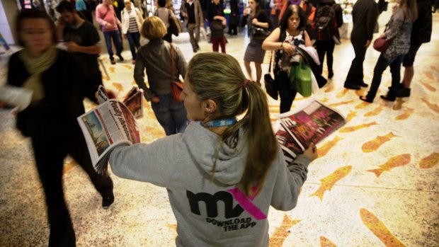 <i>mX</i> newspapers are handed out to
commuters at Sydney Town Hall on Thursday.