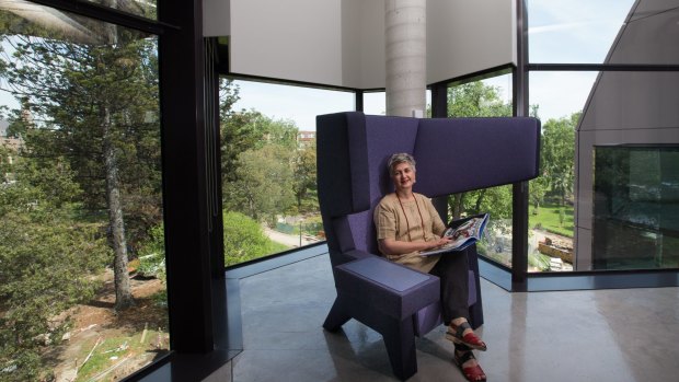 Geelong Regional Libraries CEO Patti Manolis tests out a reading chair that helps muffle noise.
