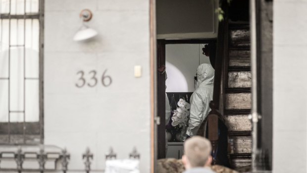 Forensic officers search a property in Surry Hills on Sunday.