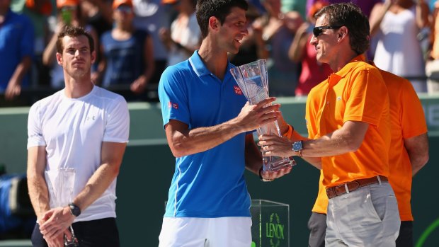 Great rivals: Andy Murray looks on as Novak Djokovic is presented with the trophy at the Miami Open this week,