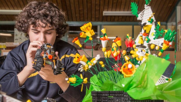 Year 10 Woden school student Jack Froggatt, 15, plays with some Lego in memory of student Mark Roberts who died last year due to complications from muscular dystrophy.