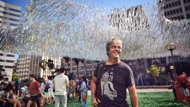 Artist Patrick Shearn with his previous aerial sculpture, Liquid Shard, in Los Angeles.