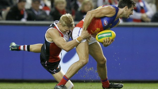 True grit: Nick Riewoldt gets to grips with the Lions Sam Mayes.