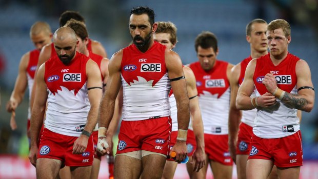 Hurting: The Swans trudge off after their round-16 drubbing by Hawthorn.