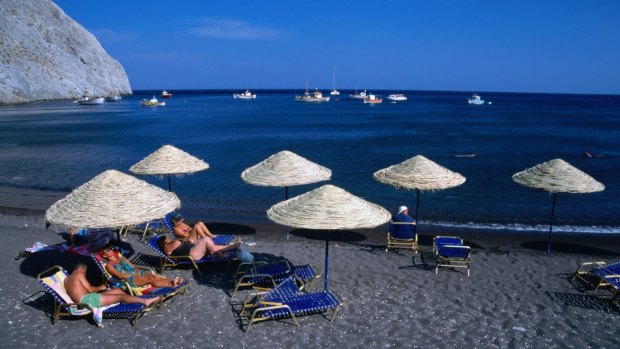 Time out of the rat race on the black sands of Perissa beach on Santorini.