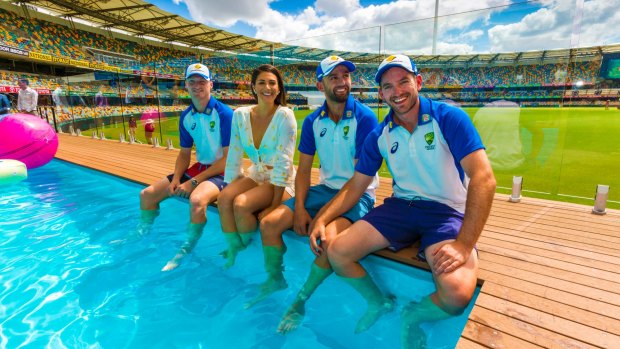 Australian cricketer Jackson Bird, former Olympic swimmer and Pool Deck ambassador Stephanie Rice and cricketers Nathan Lyon and Chadd Sayers pose at the pool deck at the Gabba.