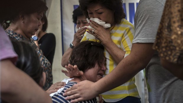 Relatives of missing AirAsia passengers grieve in Indonesia.