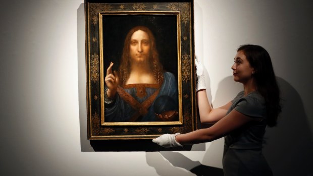 A Christie's employee with 'Salvator Mundi' before it sold for a record a record $450 million.