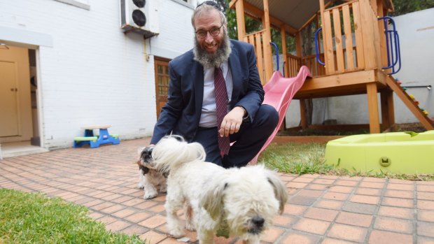 Rabbi Mendel Kastel with two dogs at Jewish House. The crisis centre is one of the only places people in crisis can also bring their pets. 
