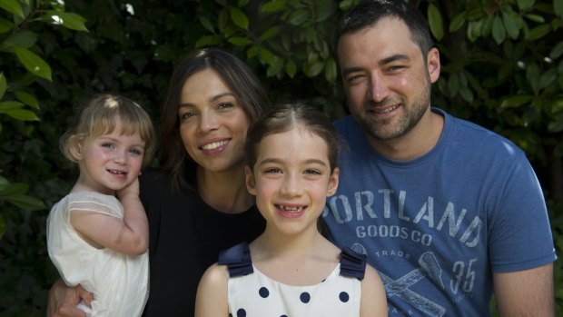 Ava Bancroft, 8, with her sister Imogen, 2, mum Tegan and dad James. 