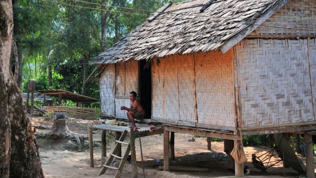 Traditional Hmong village house on stilts on the banks of The Mekong River, Northern Laos.