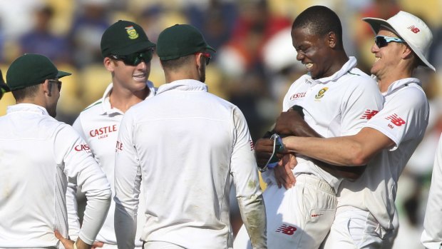 South Africa's Kagiso Rabada is lifted up by Morne Morkel after he claimed the wicket of Ravindra Jadeja.