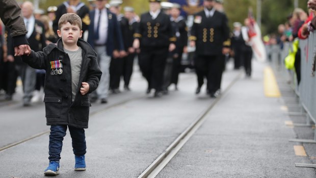  A young boy takes part in the ANZAC Day parade. 