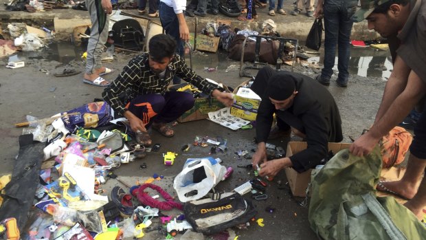 Street vendors collect their belongings after a deadly bombing attack in Sadr City, Baghdad, on Sunday.