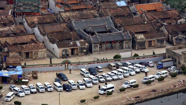 Police cars are seen during a raid where three tonnes of crystal meth were seized at Boshe village, Lufeng, Guangdong province in 2013.