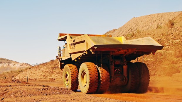 Iron ore is headed for a third year of losses, but the mining giants stay intent on boosting output to flush out smaller rivals.