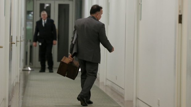 Deputy government whip Andrew Nikolic arrives to the partyroom with the ballot boxes.