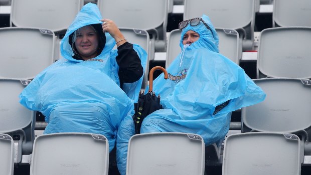 Spectators brave the rain at Pan Pacs on the Gold Coast.
