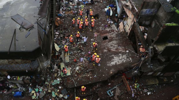 Rescue workers search among the debris at the site of building collapse in Bhiwandi.