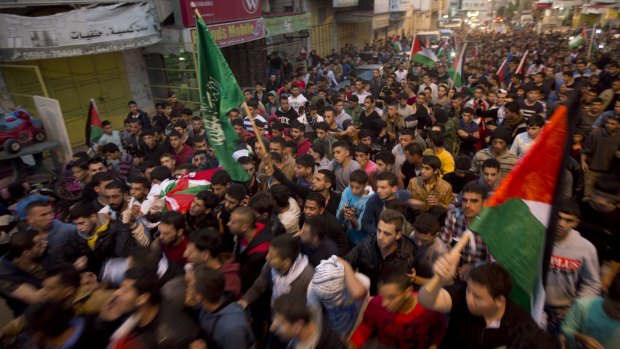 Palestinians carry the body of Mahmoud Sabaaneh, killed when he ran towards a checkpoint holding a knife in a separate incident, at his funeral on Friday.