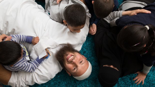 Carers Samah Al-Ali and Zak Jamus with their four foster children in their Lidcombe home.