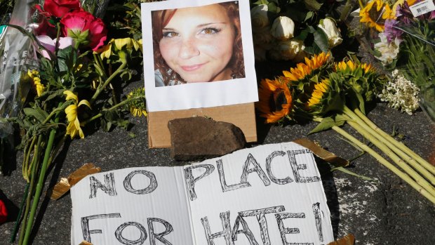 A makeshift memorial of flowers and a photo of Heather Heyer sits in Charlottesville.