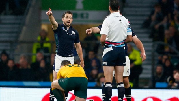 Greig Laidlaw of Scotland talks to referee Craig Joubert after he awarded the late penalty to Australia.