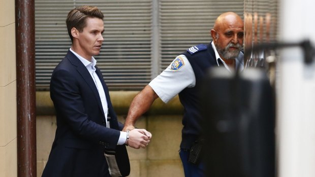 Convicted insider trader Oliver Curtis being escorted to a prison truck in June.