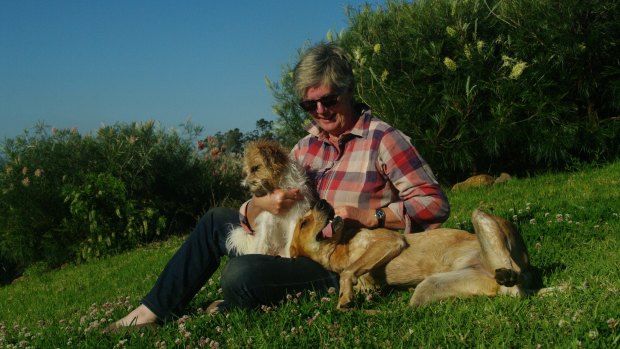 Author Susan Duncan with her dogs on her farm in the Manning Valley, NSW.