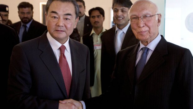 Chinese Foreign Minister Wang Yi, left, shakes hands with Pakistani national security adviser Sartaj Aziz in Islamabad on Thursday.