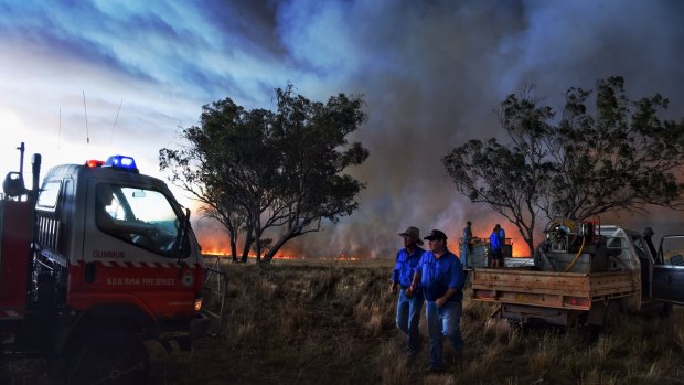 Farmers battle a fire that started with a lightning strike near a larger blaze west of Cassilis.