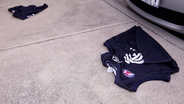Carlton jumpers lie on the ground outside Princes Park after an angry fan threw them away on Tuesday.