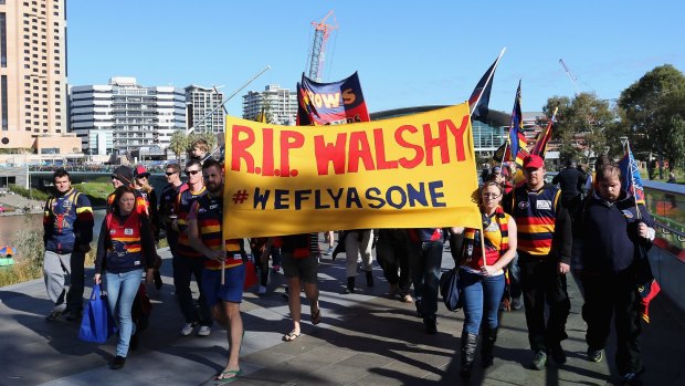 Fans marched to Adelaide Oval in silence.