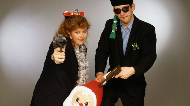 Singers Kirsty MacColl and Shane MacGowan with toy guns and an inflatable Santa after recording 'Fairytale of New York'. 